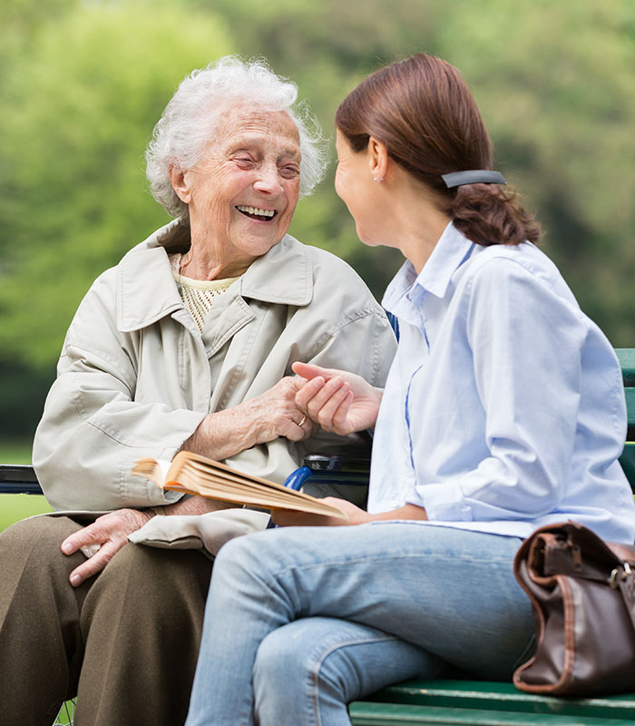 Senior woman with caregiver in the park
